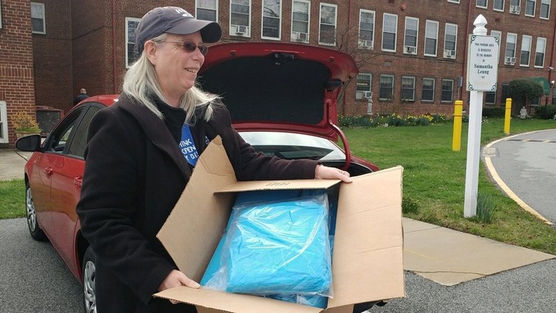 Peg Prentice, biomedical program director at The Catholic High School of Baltimore, carries medical supplies March 24, 2020, that will be donated to Mercy Medical Center amid the coronavirus pandemic. The Diocesan Fiscal Management Conference said one in five Catholic entities that applied received funds under a $349 billion federal small business loan program designed to keep people employed for up to eight weeks in response to the coronavirus pandemic. (CNS photo/courtesy The Catholic High School of Baltimore)