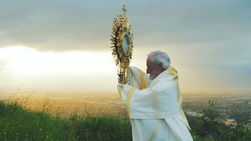 Auxiliary Bishop David G. O'Connell of Los Angeles climbs a high summit in the San Gabriel Valley April 23, 2020, to bless the most populous counties of Southern California and beyond during the coronavirus pandemic. (CNS photo/Kenny McCann, Ronin 7 Entertainment courtesy Virgin Most Powerful Radio)