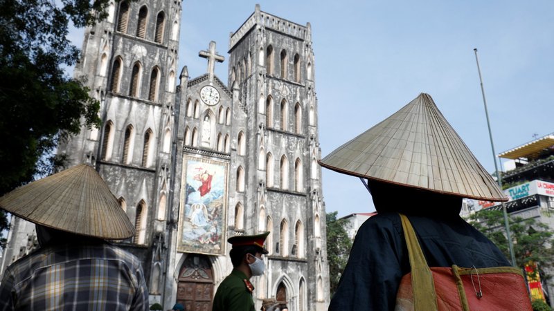 People wait to receive rice donations in front of St. Joseph's Cathedral in Hanoi, Vietnam, April 27, 2020, during the COVID-19 pandemic. (CNS photo/Kham, Reuters)