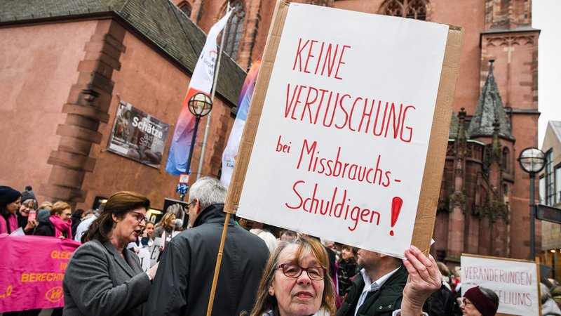 A woman near the cathedral in Frankfurt, Germany, holds a sign Jan. 30, 2020, that reads, "No coverup for those guilty of abuse!" (CNS photo/Harald Oppitz, KNA)