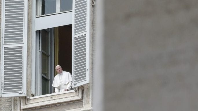 Pope Francis looks out during his noon blessing from the window of his studio overlooking an empty St. Peter's Square, due to anti-coronavirus lockdown measures, at the Vatican,, Monday, April 13, 2020. (Andrew Medichini/AP via Crux)