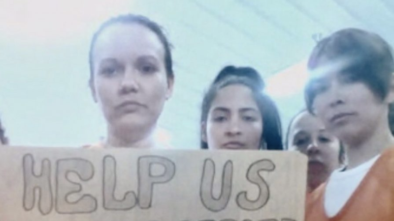 Migrants detained in an Immigration and Customs Enforcement facility in Basile, La., display signs April 3, 2020, related to the coronavirus disease. (CNS photo/Handout via Reuters)