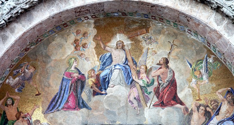 Exterior mosaic of Jesus the King in heaven, with Mary and St. John the Baptist in the main portal of St. Mark Cathedral in Venice, Italy. (Shutterstock)