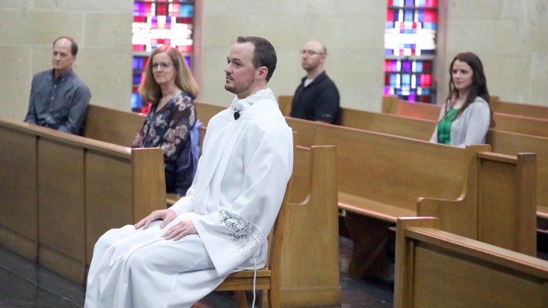 Deacon Brian McCaffrey and his immediate family listen to the homily of Bishop Gerald L. Vincke of Salina, Kan., in Sacred Heart Cathedral April 18, 2020, during the coronavirus pandemic. McCaffrey was ordained a transitional deacon. (CNS photo/Karen Bonar, The Register)