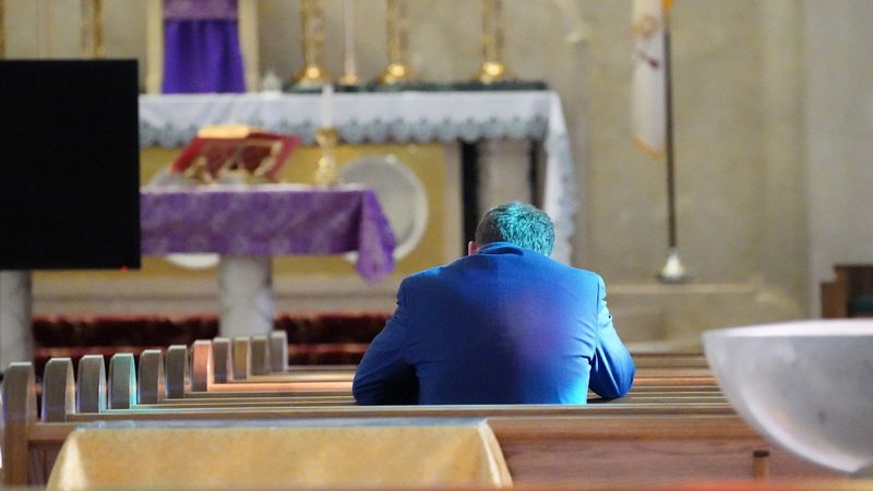 A man prays March 21, 2020, at St. Patrick Church in Huntington, N.Y., during the coronavirus pandemic. Church life is expected to reflect new practices when public Masses resume. (CNS photo/Gregory A. Shemitz, Long Island Catholic)