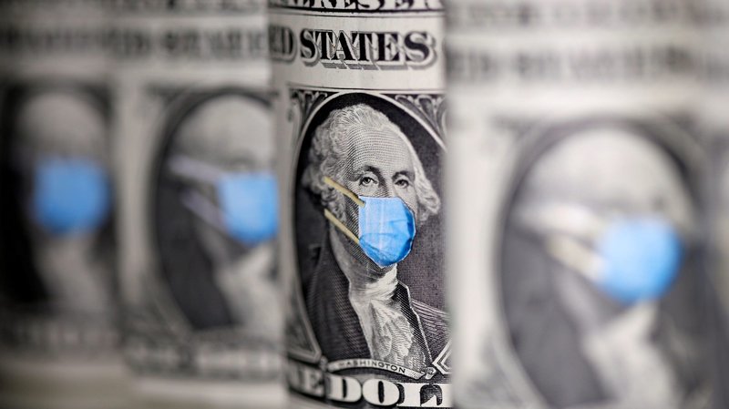 U.S. dollars are seen with face masks during the coronavirus pandemic in this illustration photo. Dioceses are helping parishes tap revenue streams while Masses are canceled because of the health crisis. (CNS photo/Dado Ruvic, Reuters)
