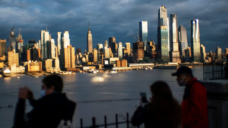 People in Weehawken, N.J., look at the New York City skyline April 18, 2020, during the coronavirus pandemic. Catholic advocates and religious communities in a May 5, 2020, letter urged Congress to address environmental justice, health care and access to safe drinking water for minority communities as part of its response to the coronavirus pandemic. (CNS photo/Eduardo Munoz, Reuters)
