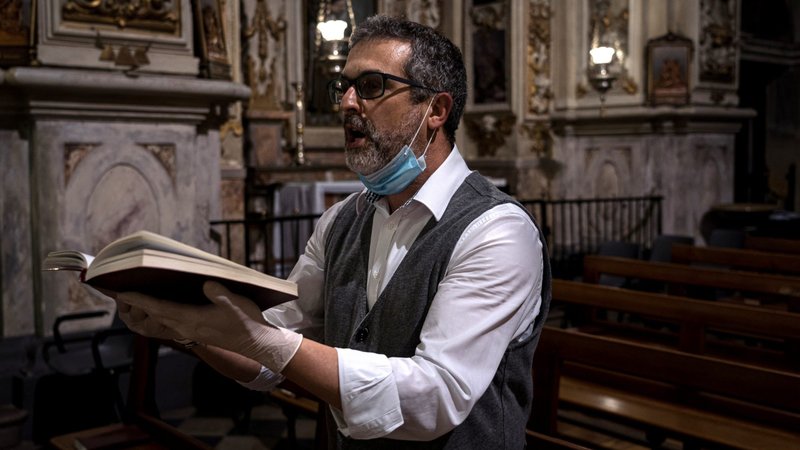 A choir singer gives a solo performance in an empty church during a Mass via livestream in San Fiorano, Italy, May 6, 2020, during the COVID-19 pandemic. (CNS photo/Marzio Toniolo via Reuters)