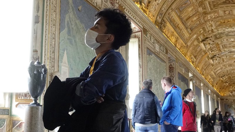 A visitor wears a mask for protection from the coronavirus while touring the Vatican Museums in this Feb. 29, 2020, file photo. A Vatican City official said that the Vatican Museums will have new measures and protocols in place to ensure the safety of visitors when they reopen. No date has been given for reopening the Museums, which have been closed since March 9 on account of the coronavirus pandemic. (CNS photo/Paul Haring)