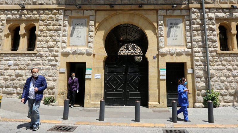 People wearing protective masks walk outside American University of Beirut May 7, 2020, during the COVID-19 pandemic. Pope Francis donated $200,000 to fund educational scholarships in Lebanon, which is facing a devastating economic crisis compounded by the coronavirus pandemic. (CNS photo/Aziz Taher, Reuters)