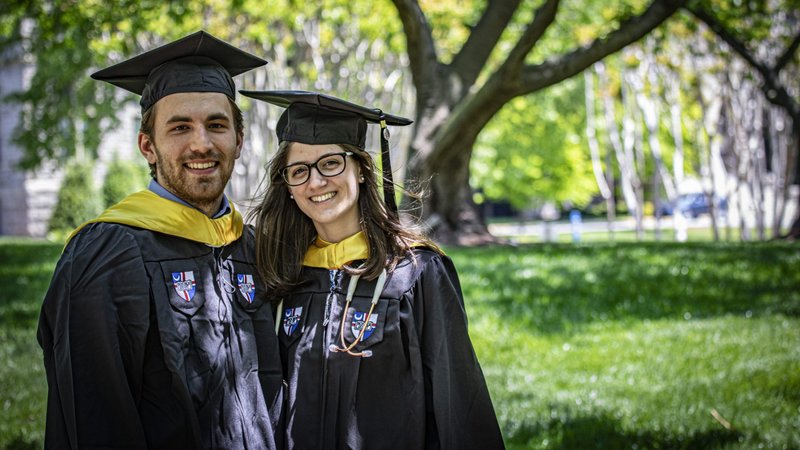 Nicholas Trotto, 22, of Glendora, N.J., and Sara Affleck, 22, of Huntingdon Valley, Pa., both soon to be graduates of The Catholic University of America, donned their cap and gowns and posed for commencement photos on the school's Washington campus May 13, 2020. Like other Catholic colleges throughout the U.S., CUA plans to hold a virtual graduation through an online platform May 16, 2020, amid the COVID-19 pandemic. (CNS photo/Chaz Muth)