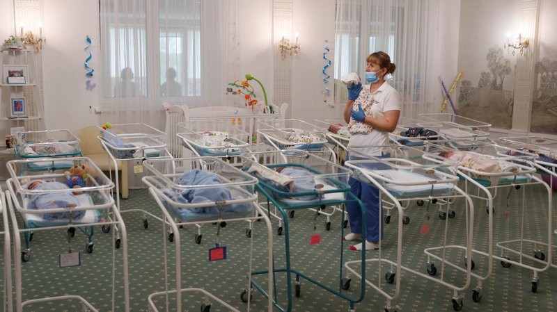 A nurse and newborns are seen in the Hotel Venice, which is owned by BioTexCom. a surrogacy agency in Kyiv, Ukraine, May 14, 2020. Dozens of babies born to surrogate mothers are stranded in Ukraine as the COVID-19 pandemic lockdown prevents their foreign parents from collecting them. The country's Catholic bishops have called for a halt to commercial surrogacy. (CNS photo/Gleb Garanich, Reuters)
