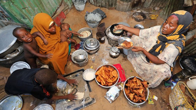 An internally displaced Somali woman and her children prepare their meal at a makeshift camp in Mogadishu, Somalia, May 8, 2020, during the COVID-19 pandemic. (CNS photo/Feisal Omar, Reuters)