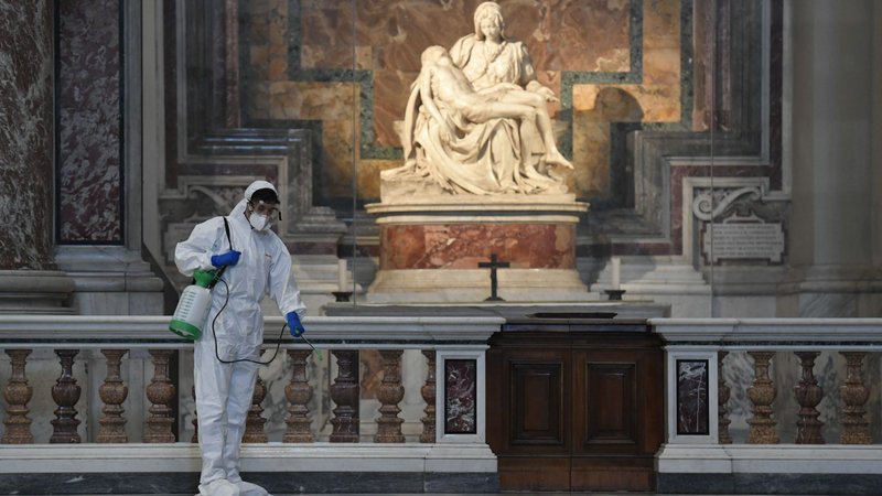 Vatican workers in protective gear sanitize various surfaces near Michelangelo's Pieta inside St. Peter's Basilica at the Vatican May 15, 2020, ahead of the resumption of Masses during the COVID-19 pandemic. (CNS photo/Vatican Media)