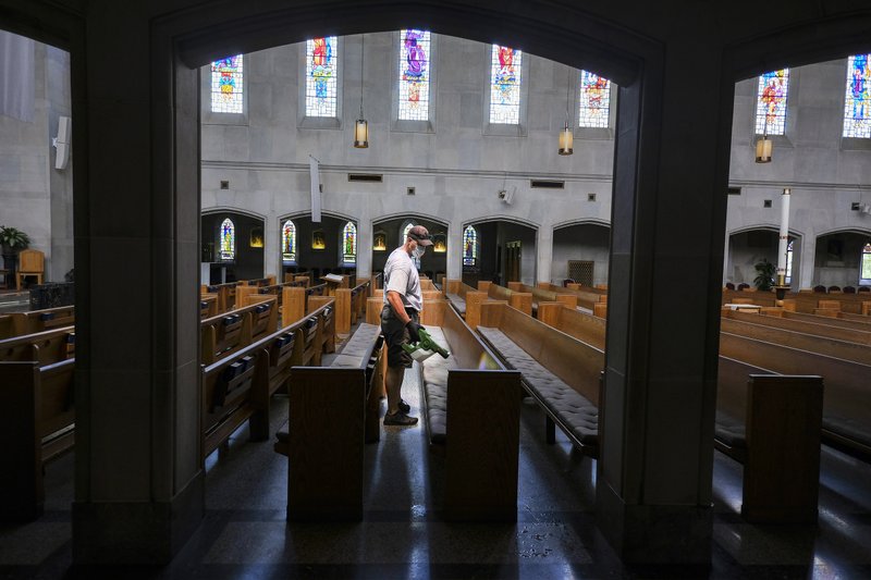 Mike Decker of Nashville, Tenn., applies an electrostatic disinfectant at Christ the King Church May 15, 2020. (CNS photo/Rick Musacchio, Tennessee Register)