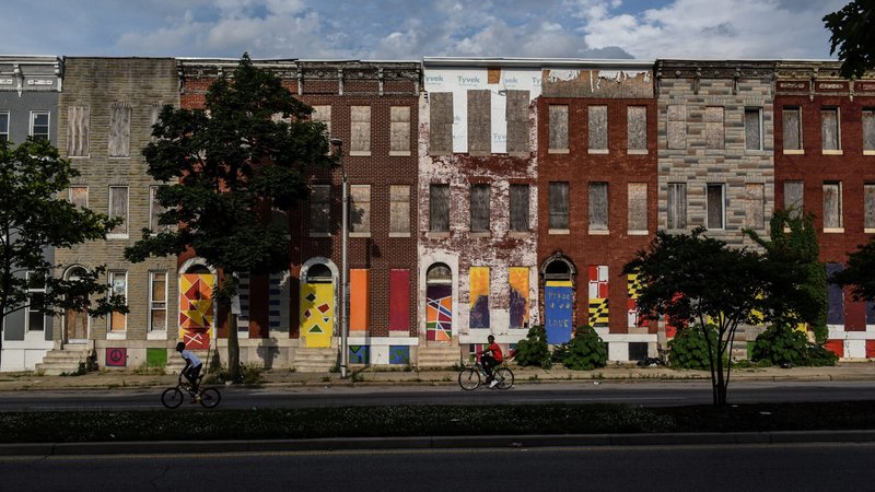 Boys ride their bikes past boarded-up and abandoned rowhouses in Baltimore May 26, 2019. Archbishop Paul S. Coakley of Oklahoma City, chairman of U.S. bishops' Committee on Domestic Justice and Human Development, said May 22 the next federal stimulus package for pandemic economic relief must include help for the poor and vulnerable. (CNS photo/Stephanie Keith, Reuters)