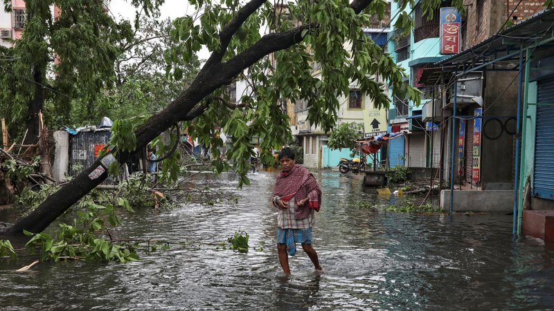 A man crosses a flooded street in Kolkata, India, May 21, 2020, after Cyclone Amphan made its landfall. Following the cyclone, incessant rain and floods have forced hundreds of thousands of people to move to safer places in eastern India's Assam state. (CNS photo/Rupak De Chowdhuri, Reuters)