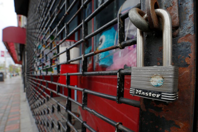 A store in Chelsea, Mass., is locked and barred May 11, 2020, amid the coronavirus pandemic. (CNS photo/Brian Snyder, Reuters) See IN-DEPTH-ECONOMY May 29, 2020.