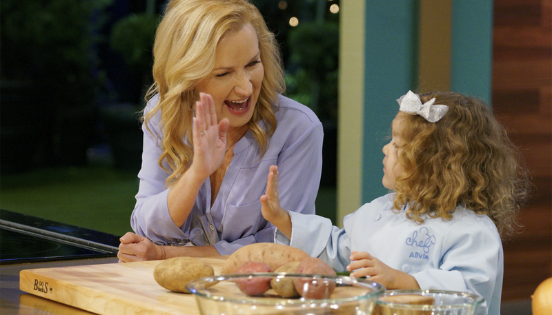 Host Angela Kinsey with a young contestant on the premiere episode of "Be Our Chef" on Disney+. (Scott A. Miller, Disney+)