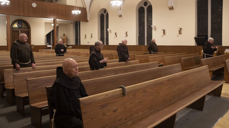 Franciscan friars pray at St. Anthony of Padua Church in Butler, N.J., April 11, 2020. The U.S. Supreme Court rejected appeals to lift restrictions limiting congregation sizes May 29 during the coronavirus pandemic. (CNS photo/Octavio Duran)
