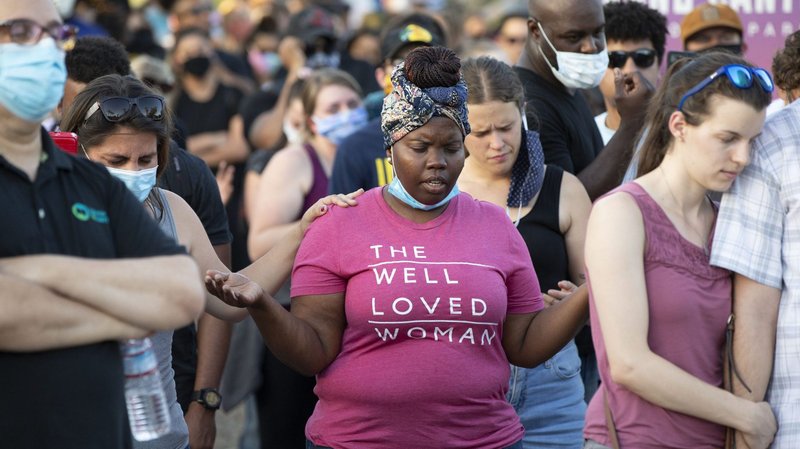 Protesters pray together during a protest at Memorial Plaza in Phoenix June 2, 2020, following the death of George Floyd, an African American man who was taken into custody by Minneapolis police and later died at a Minneapolis hospital. (CNS photo/Rob Schumacher, The Republic, USA TODAY NETWORK via Reuters)