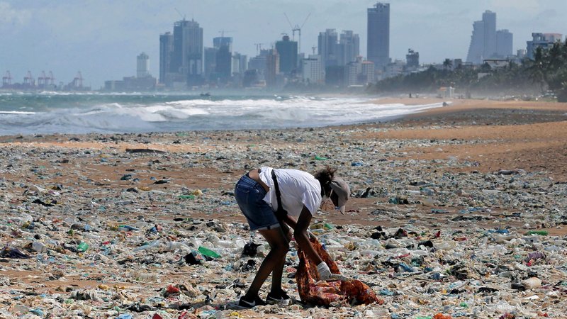 A volunteer collects garbage on a beach in Colombo, Sri Lanka, June 5, 2020, during an event to mark World Environment Day. The theme of World Environment Day 2020 is "Celebrate Biodiversity." (CNS photo/Dinuka Liyanawatte, Reuters)