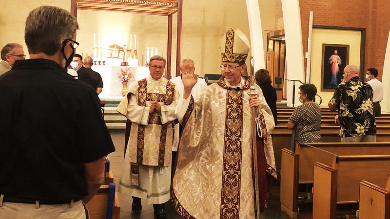 Phoenix Bishop Thomas J. Olmsted waves to people in the pews following a special Mass for the forgiveness of the sin of racism at Ss. Simon and Jude Cathedral in Phoenix June 8, 2020. (CNS photo/Tony Gutierrez)
