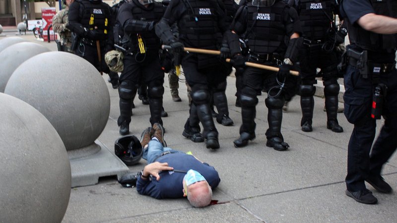 Martin Gugino, a 75-year-old protester and longtime Catholic Worker peace activist, lies on the ground after he was shoved by two Buffalo police officers June 4, 2020, during a protest against police violence against minorities. (CNS photo/Jamie Quinn, Reuters)