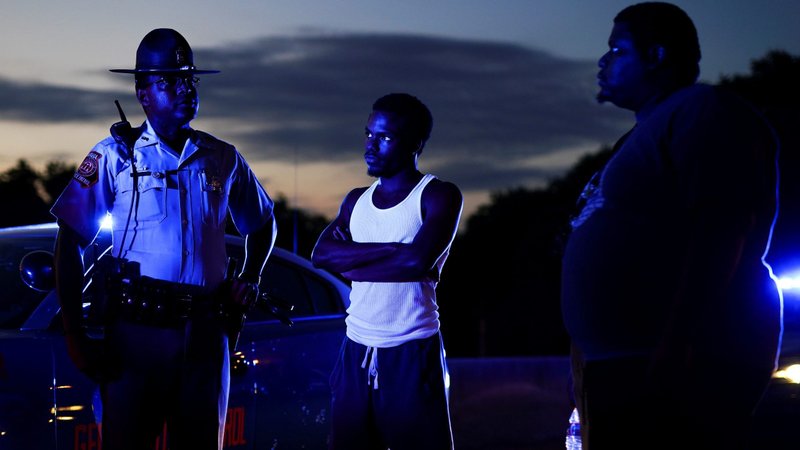 Two protesters in Atlanta speak with a Georgia State Patrol officer after taking over and blocking a freeway June 13, 2020. Rayshard Brooks was seen on video resisting arrest and running away from two police officers during a June 12 traffic violation investigation. (CNS photo/Elijah Nouvelage, Reuters)