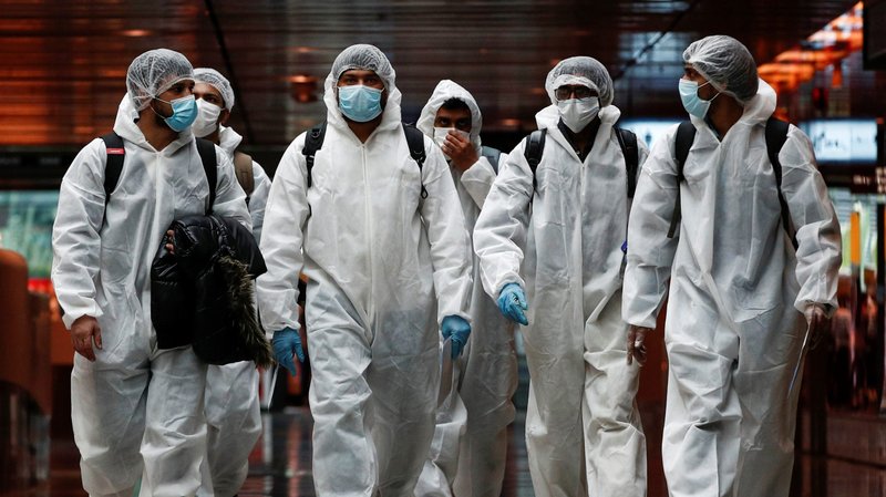 Seafarers who have spent months working onboard vessels during the COVID-19 pandemic arrive June 12, 2020, at Changi Airport in Singapore. (CNS photo/Edgar Su, Reuters)