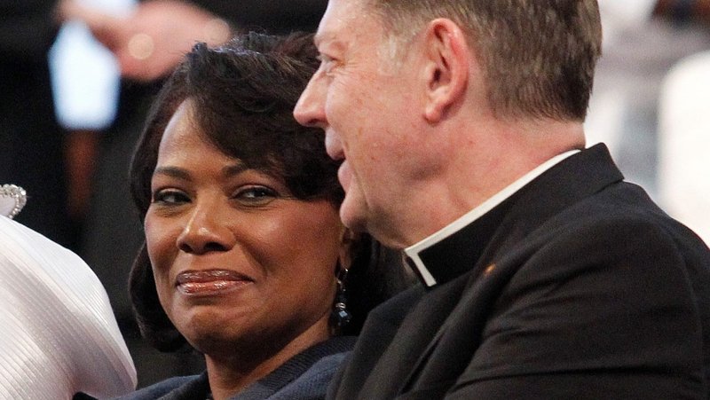 A file photo shows the Rev. Bernice King, daughter of the Rev. Martin Luther King Jr., center, alongside Father Michael Pfleger, pastor of St. Sabina Parish in Chicago, as they sing "We Shall Overcome" during a service in honor of her father at Ebenezer Baptist Church in Atlanta. (CNS photo/Tami Chappell, Reuters)