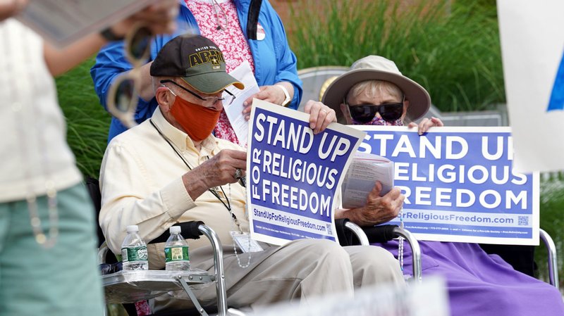 Eric and Anne Waxman recite the rosary while participating in a roadside prayer rally marking Religious Freedom Week at St. James Church in Setauket, N.Y., June 24, 2020. (CNS photo/Gregory A. Shemitz)