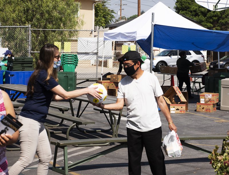 Free play equipment was distributed to local youth May 28 at Our Lady of Guadalupe School in East LA thanks to a partnership between the Department of Catholic Schools with the Play Equity Fund and LA84 Foundation. The initiative was meant to encourage outdoor activities for youth confined at home due to COVID-19 restrictions. (Victor Alemán)