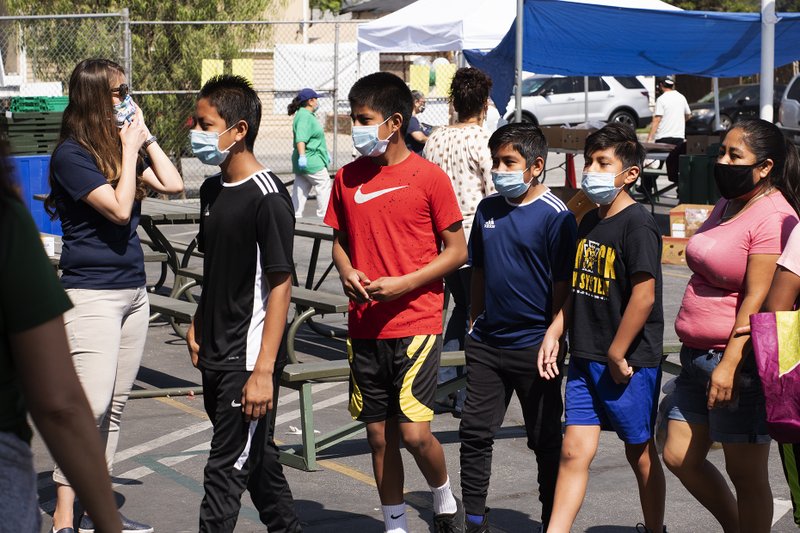 Free play equipment was distributed to local youth May 28 at Our Lady of Guadalupe School in East LA thanks to a partnership between the Department of Catholic Schools with the Play Equity Fund and LA84 Foundation. The initiative was meant to encourage outdoor activities for youth confined at home due to COVID-19 restrictions. (Victor Alemán)