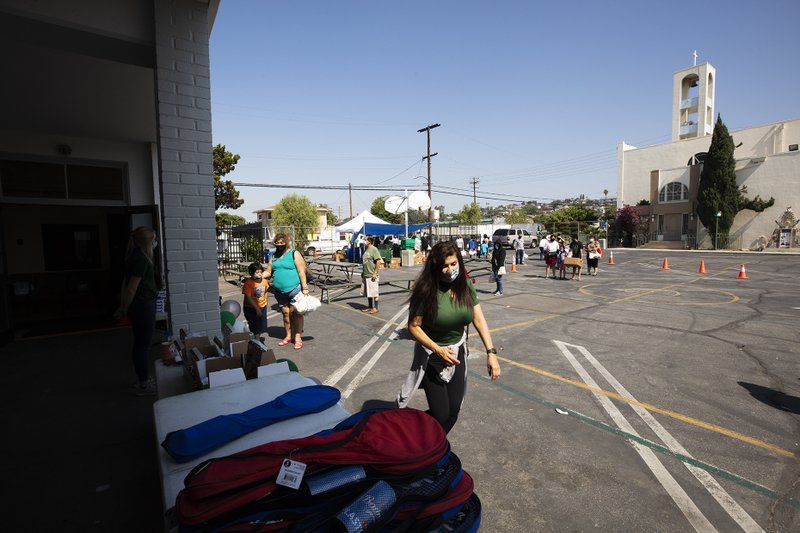 Free play equipment was distributed to local youth May 28 at Our Lady of Guadalupe School in East LA thanks to a partnership between the Department of Catholic Schools with the Play Equity Fund and LA84 Foundation. The initiative was meant to encourage outdoor activities for youth confined at home due to COVID-19 restrictions. (Victor Alemán)