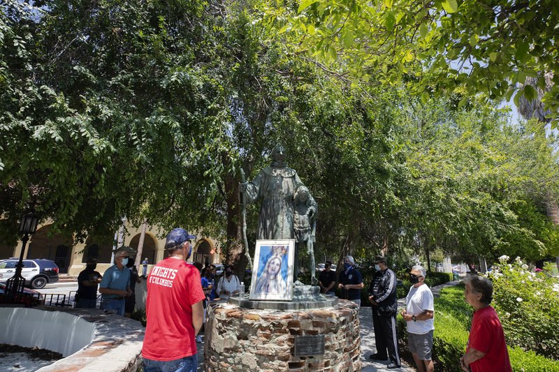 Serra supporters prayed at the statue of St. Junípero Serra at Brand Park in Mission Hills, across the street from Mission San Fernando Rey de España. The statue was recently defaced and protestors have threatened to take it down. (Victor Alemán)