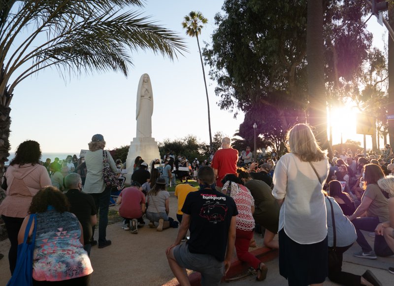 People knelt for 8 minutes and 46 seconds in silence around the statue of St. Monica during a special prayer walk and vigil to end racial inequality on June 9, the day of George Floyd's funeral. (JohnMichael Filippone)