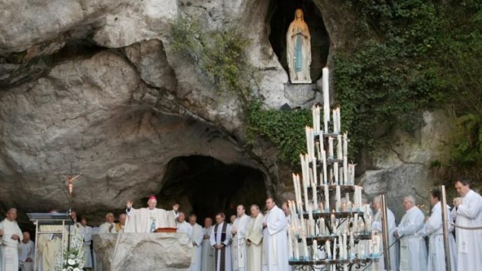 A file photo shows Mass being celebrated in the grotto at the Shrine of Our Lady of Lourdes in France. (Nancy Wiechec/CNS via Crux)
