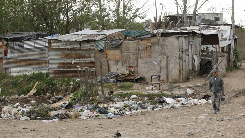 A resident is seen in a file photo walking by a shantytown near Buenos Aires, Argentina. Priests serving the shantytowns surrounding Buenos Aires warn of COVID-19 spreading through their densely populated communities. (CNS photo/Enrique Marcarian, Reuters)