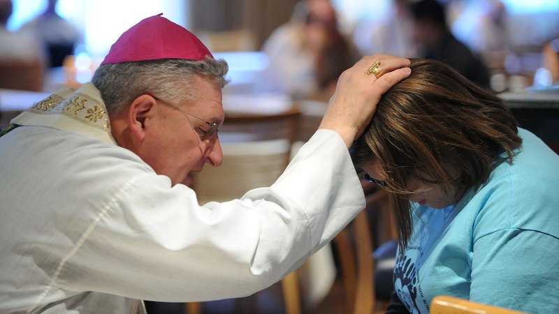 In this 2014 file photo, Bishop David A. Zubik of Pittsburgh hears a young woman's confession during a pro-life youth rally and Mass at the Verizon Center in Washington. (CNS photo/Leslie Kossoff)