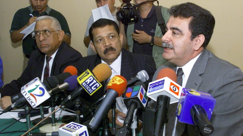 Salvadoran Gen. Rene Emilio Ponce, right, and his colleagues, Colonels Francisco Elena Fuentes, left, and Inocente Orlando Montano, center, are pictured in a 2000 photo during a news conference denying involvement in the 1989 deaths of six Jesuit priests, their housekeeper and her daughter. (CNS photo/Reuters)