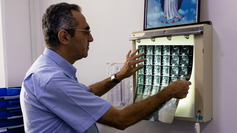 A doctor looks over an X-ray at a Catholic-run French hospital in Damascus, Syria, in this 2019 photo. Organizers of "Operation Open Hospitals in Syria" hope to provide life-saving services free of charge to vulnerable Syrians at three Catholic-run hospitals and aid some 50,000 patients by the project's end in 2021. (CNS photo/Aldo Gianfrante, courtesy AVSI)