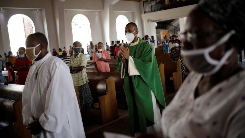 Priests, wearing face masks, process past the faithful attending the first day of Mass July 12, 2020, at the Cathedral of Port-au-Prince, Haiti, as the country reopened worship places during the coronavirus pandemic. The Vatican issued a new instruction July 20 on pastoral care that emphasizes the role of lay men and women in the church's mission, but said most parishes must be led by priests. (CNS photo/Andres Martinez Casares, Reuters)