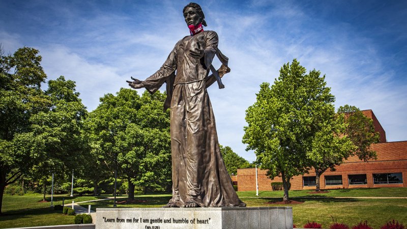 A face mask is placed on a statue called "Jesus The Teacher" on the campus of DeSales University in Center Valley, Pa., July 26, 2020. Students are bound to see big changes on Catholic college campuses throughout the U.S. as the institutions deal with the coronavirus pandemic. (CNS photo/Chaz Muth)