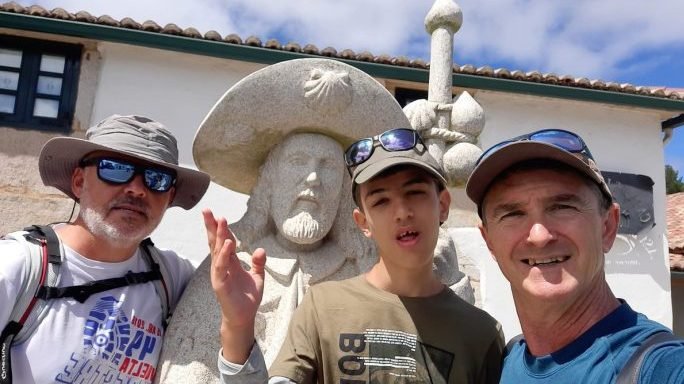 Alvaro Calvente, center, flanked by his father, Idelfonso, to his right, and family friend Francisco Javier Millan, during a stop in their pilgrimage to Santiago de Compostela. (Twitter El Camino de Alvaro via Crux)