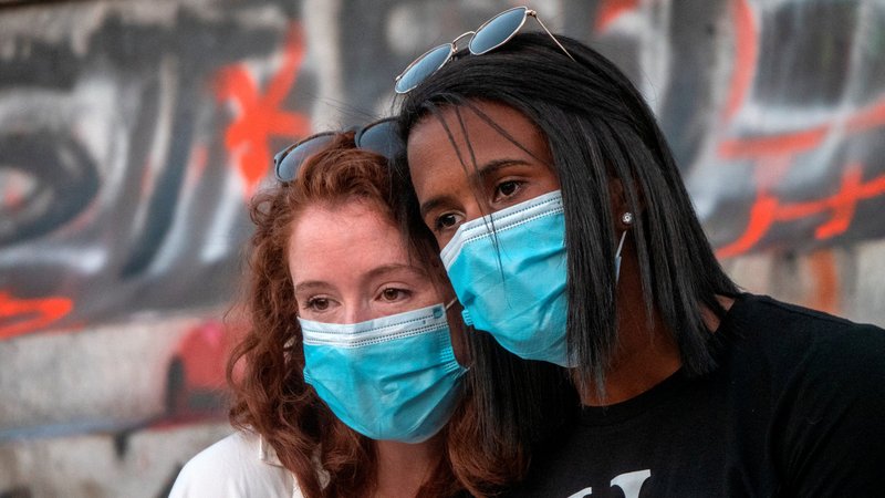 Best friends Megan Wright and Juienne Brown are seen as protesters rally around the statue of Confederate Gen. Robert E. Lee in Richmond, Va., June 12, 2020, against racial inequality and the death of George Floyd. (CNS photo/Jay Paul, Reuters)