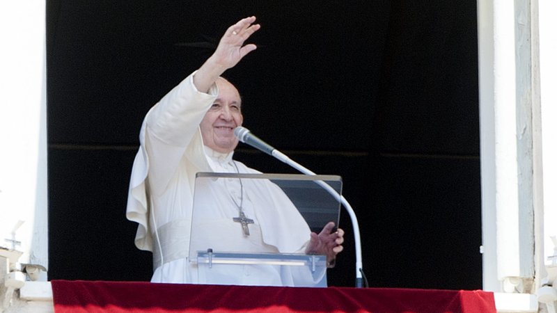 Pope Francis waves to the crowd in St. Peter's Square from a window of the Apostolic Palace at the Vatican during his July 26, 2020, Angelus address. (CNS photo/IPA/Sipa via Reuters)