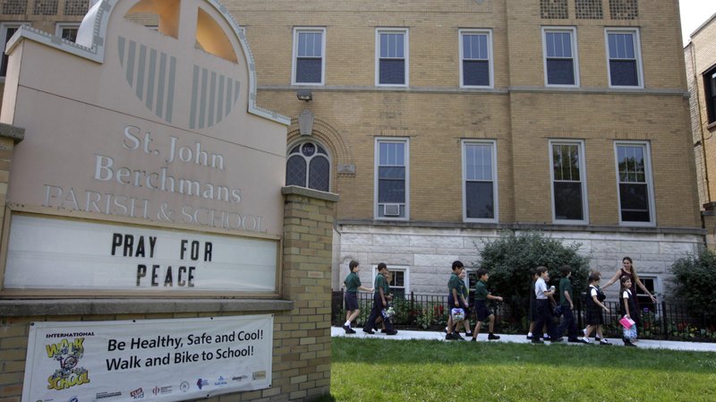 Third graders at St. John Berchmans School in Chicago walk outside of the building, in this 2013 file photo. Catholic schools, especially those serving urban areas, have been disproportionately impacted in the ongoing fallout of the coronavirus pandemic, three U.S. bishops told the Congressional Black Caucus leaders July 31, 2020. (CNS photo/Karen Callaway, Catholic New World)