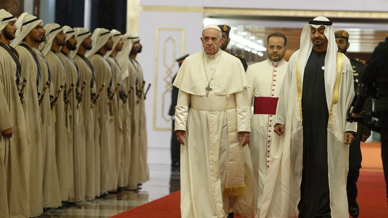 Pope Francis walks with Msgr. Yoannis Lahzi Gaid and Sheikh Mohammed bin Zayed Al Nahyan, crown prince of United Arab Emirates, upon his arrival at Abu Dhabi Presidential Flight airport in United Arab Emirates in 2019. Msgr. Lahzi Gaid has completed his service as personal secretary to Pope Francis, but will continue as a member of the interreligious committee working to fulfill the goals of the "Document on Human Fraternity for World Peace and Living Together." (CNS photo/Paul Haring)