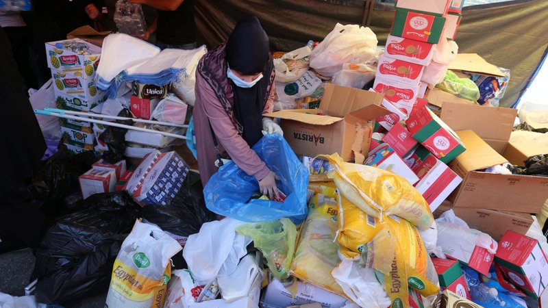 A volunteer gathers supplies in Beirut Aug. 5, 2020, to be distributed to people affected by the previous day's explosions. Beirut Gov. Marwan Abboud said up to 300,000 people were homeless and that the blasts damaged nearly half the city. (CNS photo/Aziz Taher, Reuters)